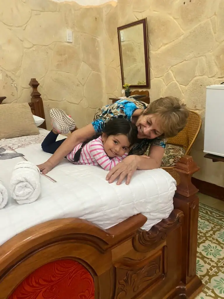 The owners of Casa AnaIsa holding a child with love and care, showing their devotion to making every young guest feel at home in Havana.